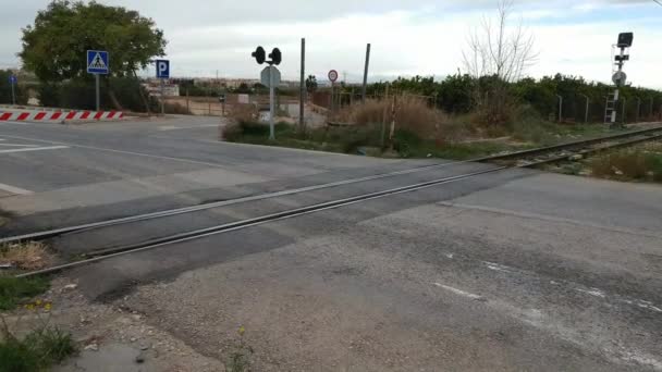 VALENCIA, SPAIN - DECEMBER 11, 2017: A Valencia Metro train crossing on a street in Valencia. The Valencia metro network consists of more than 134 kilometers (83 mi) of track, of which 19 kilometers (12 mi) is below ground. — Stock Footage Valencia Spain December 2017 Valencia Metro Train Crossing Street Valencia Stock Video