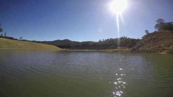 Floating across calm lake — Stock Video