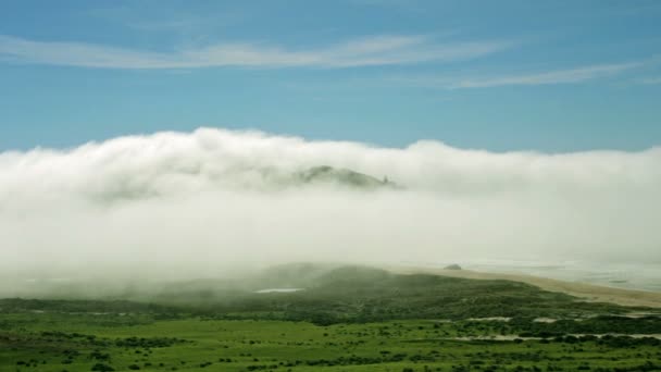 Σύννεφα που κινούνται πάνω από παράκτιο λόφο — Αρχείο Βίντεο