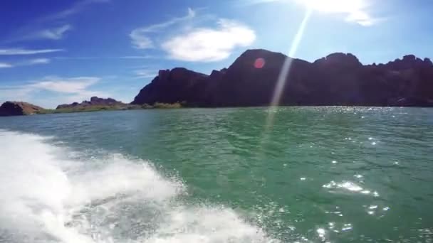 Boat drifting in sea with rocky mountains — Stock Video