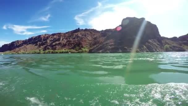Boat drifting in sea with rocky mountains — Stock Video