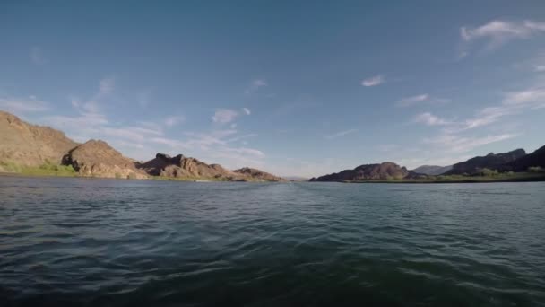 Boat drifting in sea with rocky mountains — Αρχείο Βίντεο