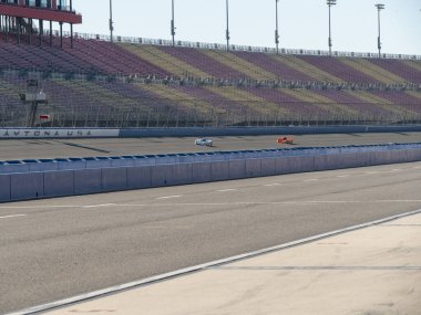 Mazda rotary powered race cars running on race track at Auto Club Speedway in California. clipart