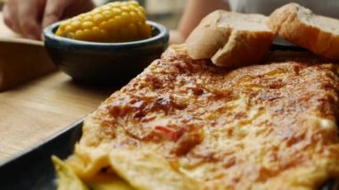 Restoranda sebzeli omlet, salata ve avokado. Bir tabakta çırpılmış yumurta. Lezzetli. Yakın plan
