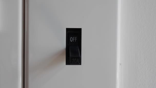 Light is On. Male hand turn on electric breaker switch. 4k — Stock Video