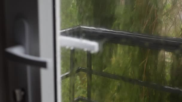 L'eau de pluie forte chasse contre le verre de fenêtre et coule vers le bas. Gros plan. Gouttes de pluie sur fond de verre en saison des pluies. 4k — Video