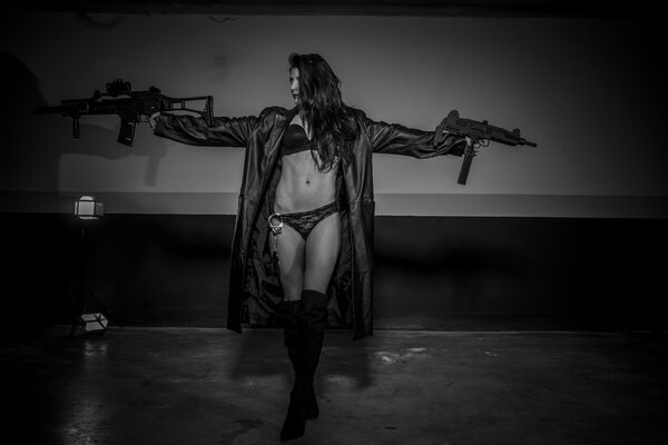 girl posing in long coat with weapons