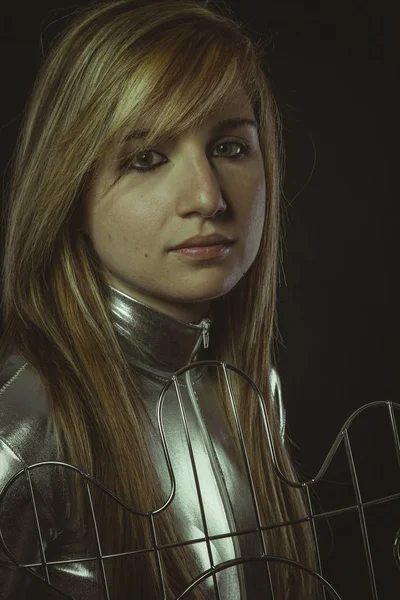 Woman posing in silver jacket with lattice — Stock Photo, Image