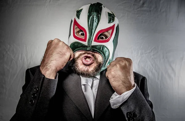 Angry businessman with mask of Mexican fighter — Stock Photo, Image