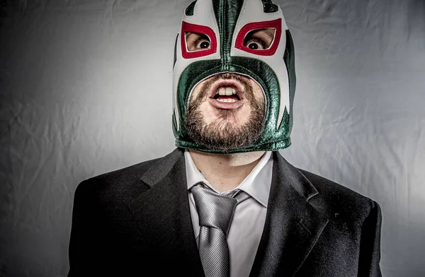 Angry businessman with mask of Mexican fighter — Stock Photo, Image