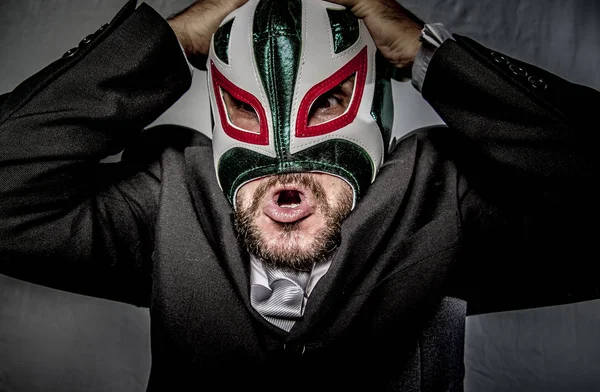 Angry businessman with mask of Mexican fighter