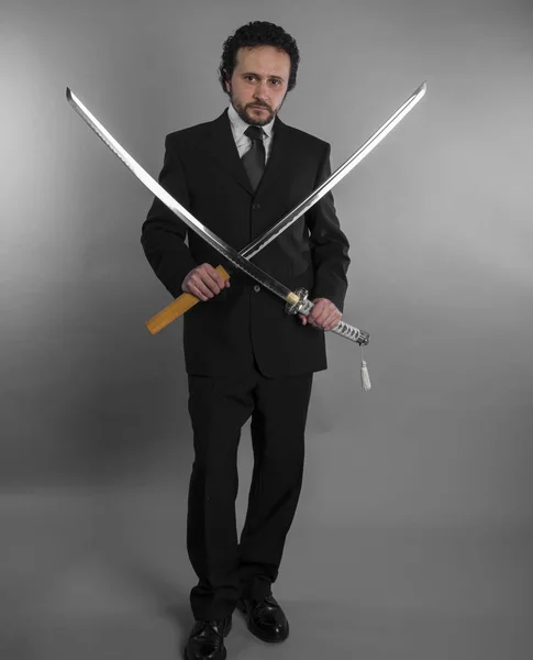 Aggressive businessman with Japanese swords — Stock Photo, Image
