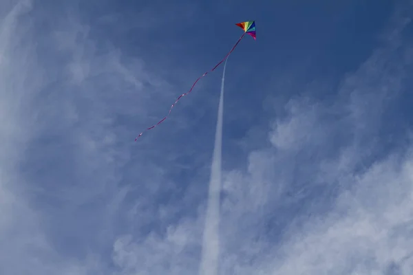 Kite of rainbow colors in sky — Stock Photo, Image