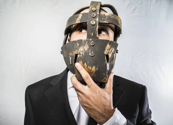 Businessman with iron mask on face