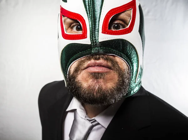 Angry businessman with mask of Mexican fighter