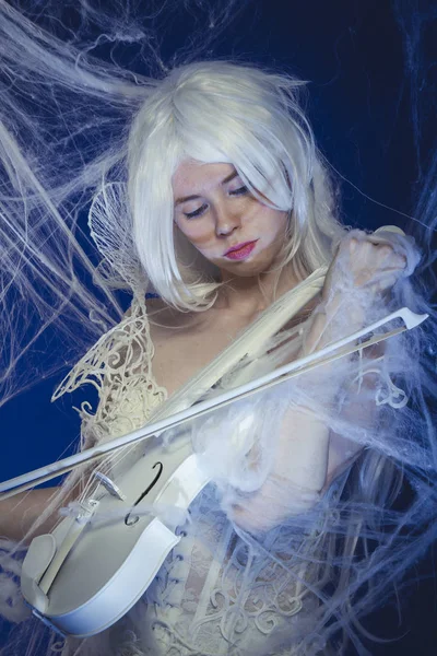woman in white playing violin