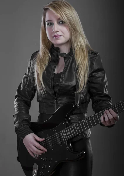 blonde with black electric guitar