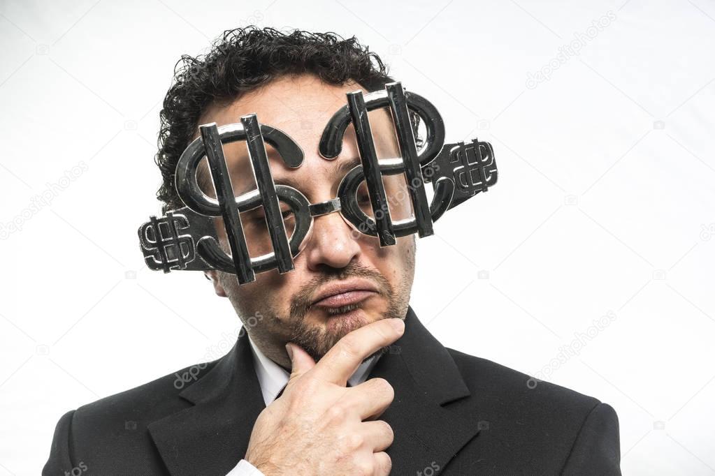Businessman wearing glasses with dollar signs