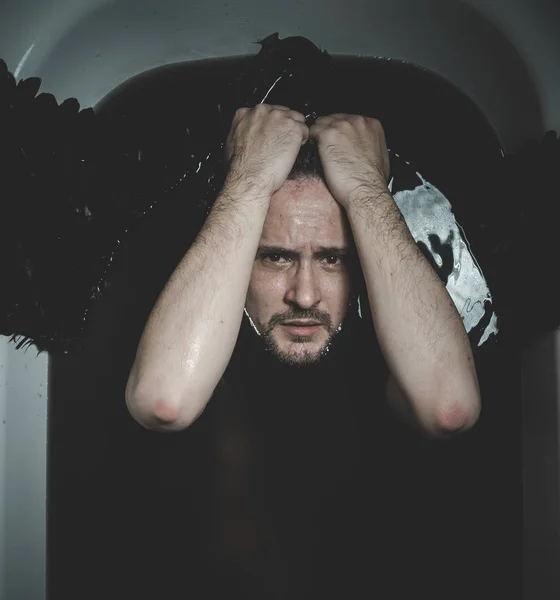Man with black water and wings — Stock Photo, Image