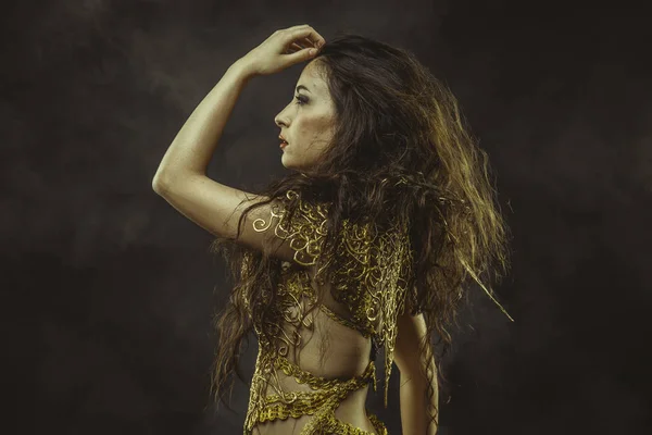 Girl in dress of golden threads — Stock Photo, Image