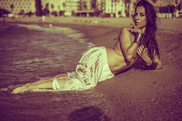 brunette girl lying on the shore