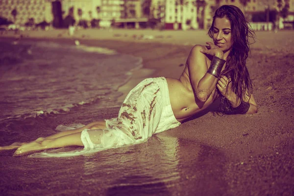 brunette girl lying on the shore