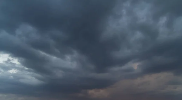 Heaven and hell, Autumn sky with dark colors and very gray clouds and rain-laden