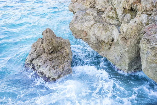 Rocks by the sea with waves of the Mediterranean sea next to the Cabo de Formentor in the Balearic Islands, Spain. Scenes of Spanish tourism