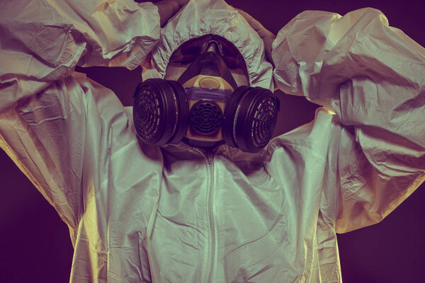 Quarantine, virus infection concept. Man in protective suit and antigas mask with glasses. Ebola, toxic gases, biological warfare, infections and diseases