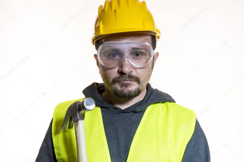man dressed in yellow builder helmet with protective glasses ready to start the construction work