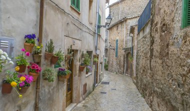 Travel Beautiful street in Valldemossa with traditional flower decoration, famous old mediterranean village of Majorca. Balearic island Mallorca, Spain clipart
