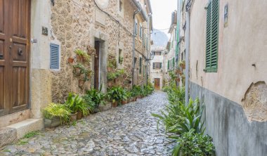 Vacation, Beautiful street in Valldemossa with traditional flower decoration, famous old mediterranean village of Majorca. Balearic island Mallorca, Spain clipart