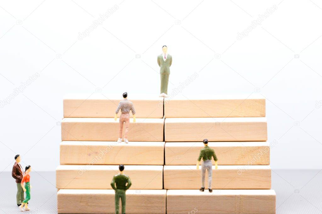 Miniature people : small figures businessmen stand and walk up