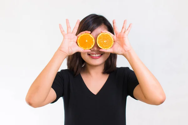 Portrait of young Asian woman. holding orange slices in front of her eyes and smile over a white background. healthy eating diet concepts. healthy food concept. — Stock Photo, Image