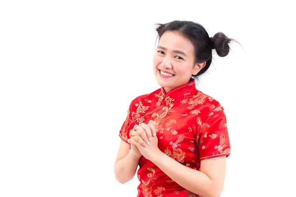 Asian woman wearing chinese dress cheongsam with gesture of congratulation, bring the hands together in greeting or obeisance and smile in Chinese New Year Festivities, New Year Celebration isolated. — Stock Photo, Image