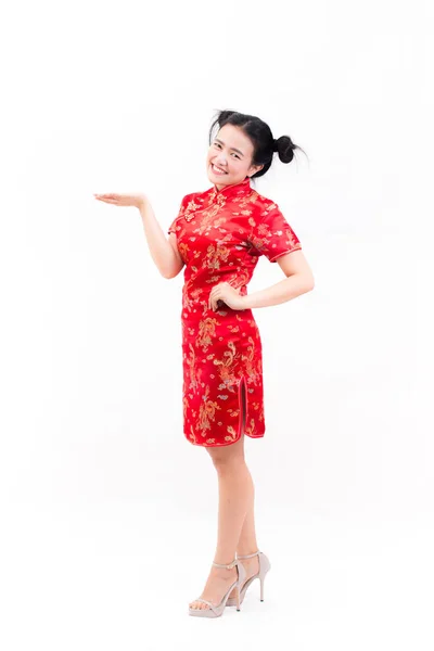 Młoda kobieta azjatyckich noszenie sukienka chińskie tradycyjne qipao gestem z gratulacjami, patrząc na kamery i uśmiech w chiński nowy rok uroczystości, obchody nowego roku na białym tle. — Zdjęcie stockowe