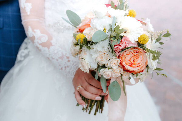 beautiful wedding bouquet with red, pink and white flowers, roses and eucalyptus, peonies, calla lilies
