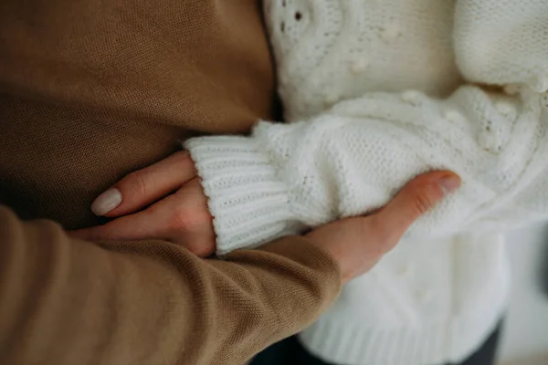 Closeup of a young woman hugging a man.