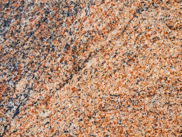 Cilalı Kızıl granit kaya yüzeyi dokusuna bir close-up — Stok fotoğraf