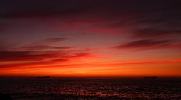 Puesta de sol en Vina del Mar, Chile Dos barcos en un mar de color naranja oscuro . — Foto de Stock