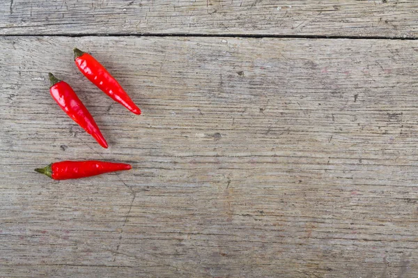 Rote Chilischoten auf Holztisch — Stockfoto