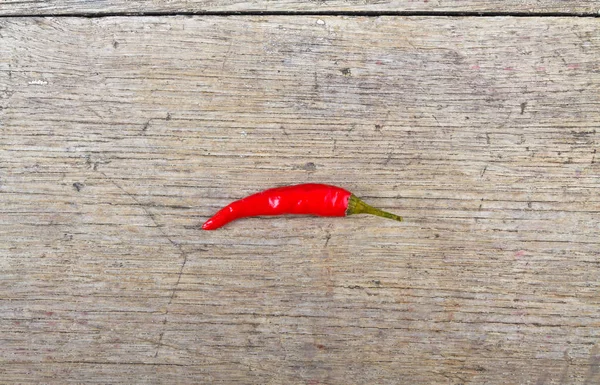 Red hot chili pepper on wooden table — Stock Photo, Image