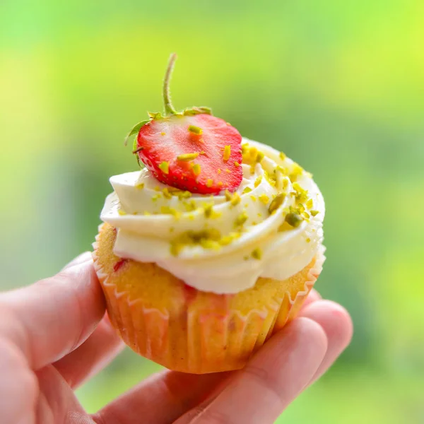 Hand with Strawberry Cupcake