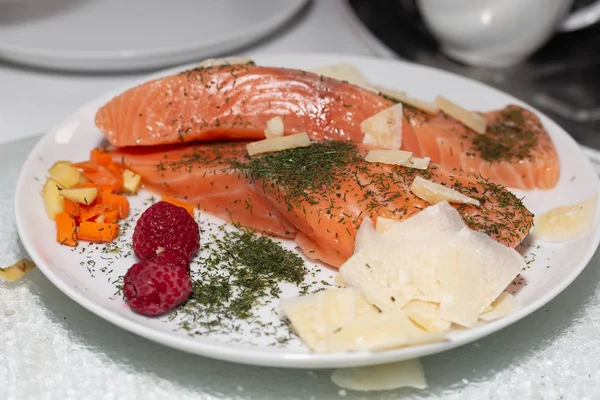 salmon dish with potatoes and carrots, raspberries and italian c