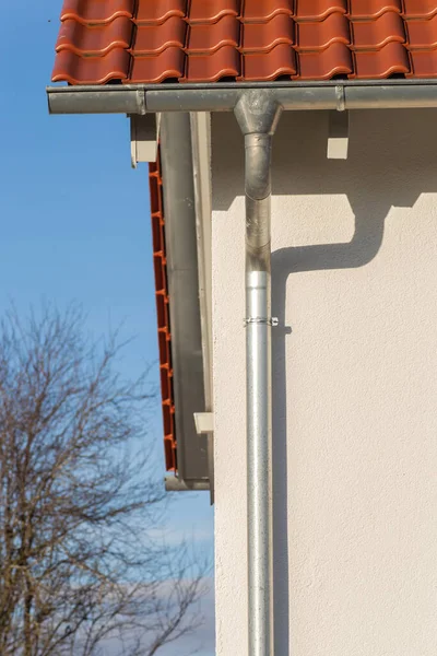 eavestrough of a rooftop of a new building in south germany sunny afternoon