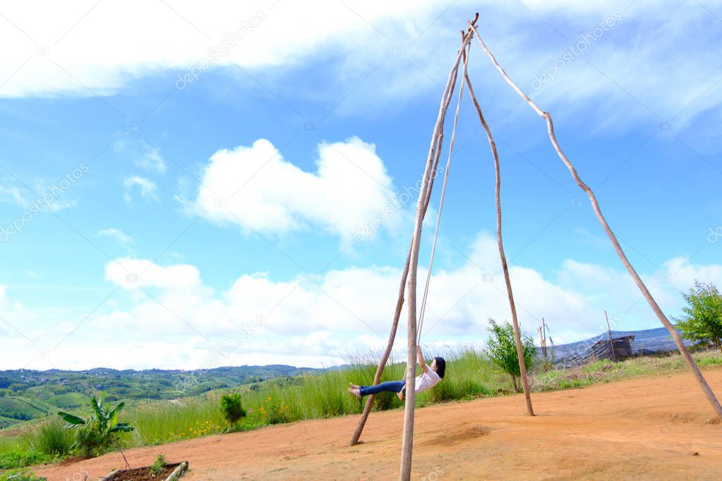 Thai female was playing wooden the swings at Khao Kho, Phetchabun