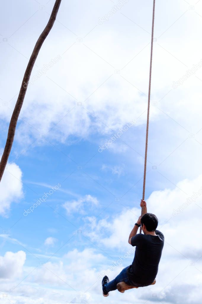 Thai male was playing wooden the swings at Khao Kho, Phetchabun