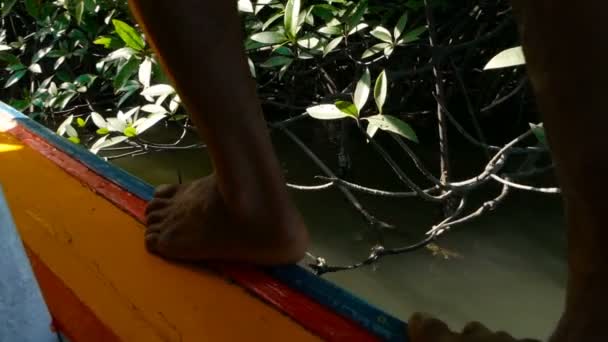 A man is walking along the adge of his fishing boat — Stock Video