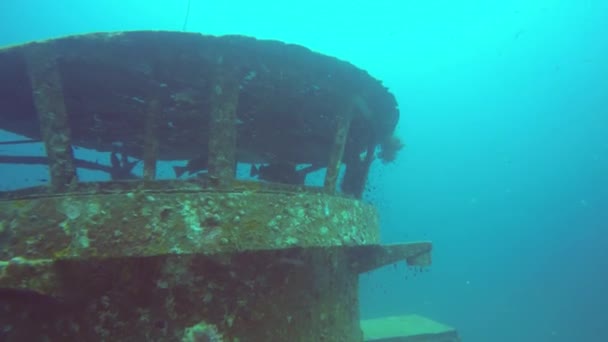 Technical wreck marine scuba diving. Old rusty wartime naval army wreckage remains on the sea bottom. Diver exploring nautical historic world war military shipwreck ruins deep under water in ocean. — Stock Video