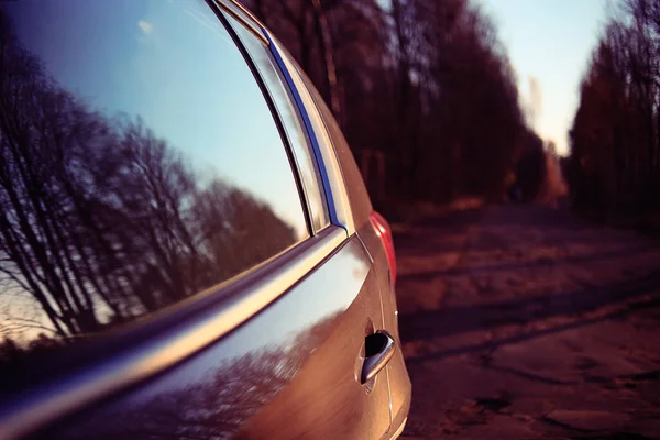 Car on autumn sunny road — Stock Photo, Image